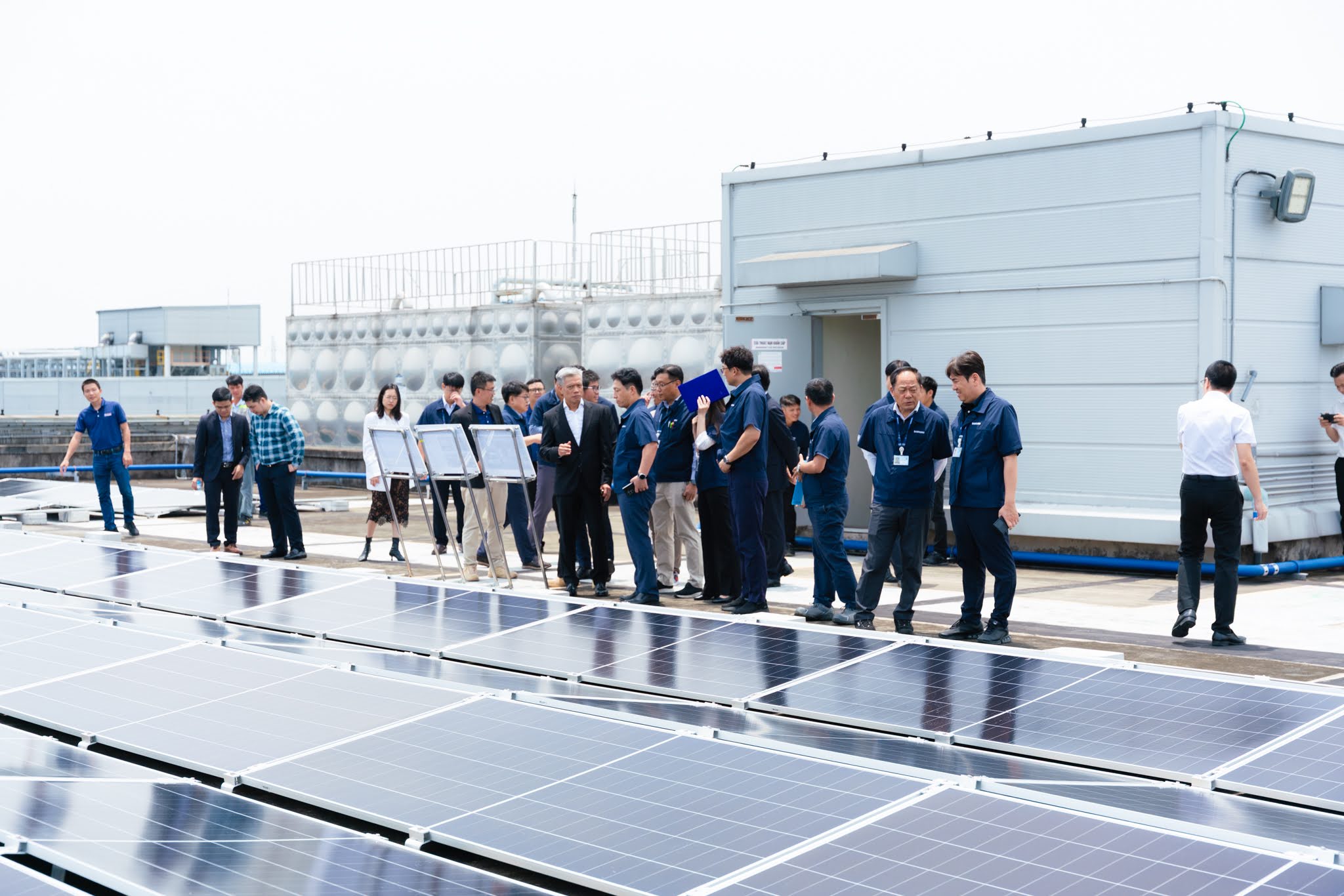 Delegates visit the rooftop solar power system at SEV